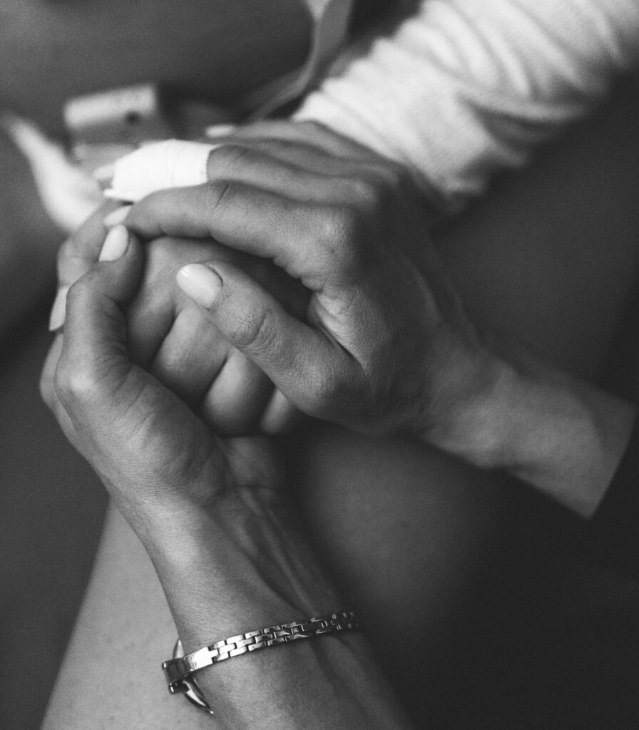Hand in hand support of the doula in the birth room Professional birth photography